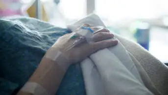 Pregnant woman with cannula in her hand