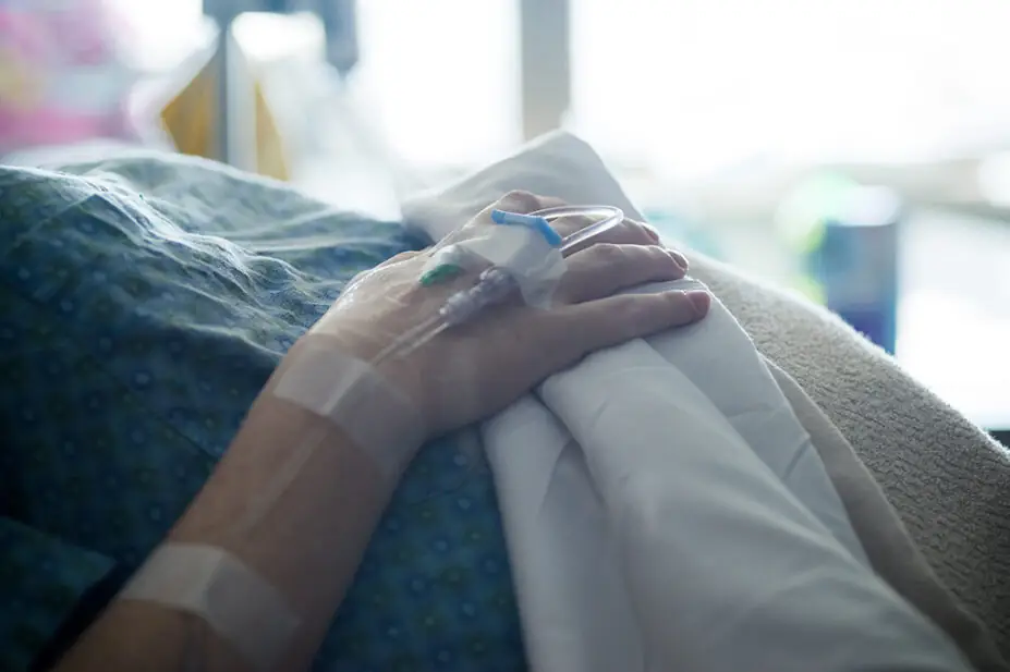 Pregnant woman with cannula in her hand