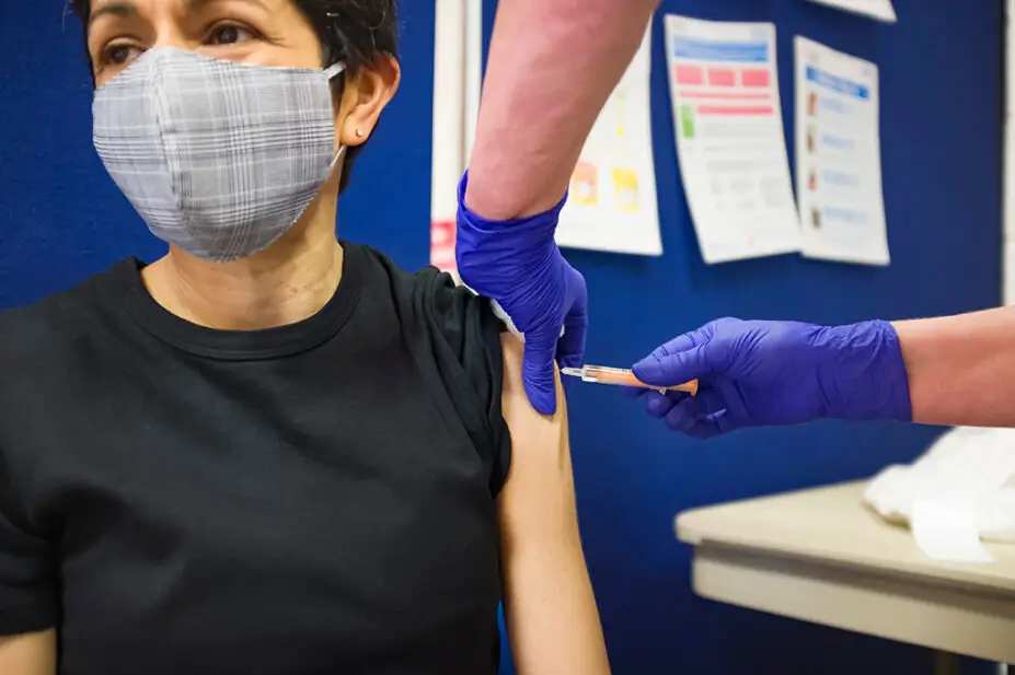 Woman receiving a vaccination in upper arm