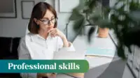 Photo of a woman looking at a paper and a laptop in an office