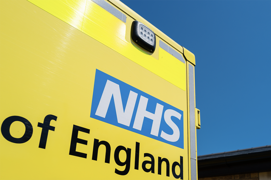 The rear of an ambulance displaying the NHS England logo