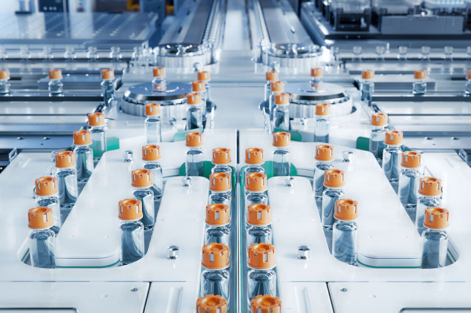 Conveyor belt with glass vials at pharmaceutical factory