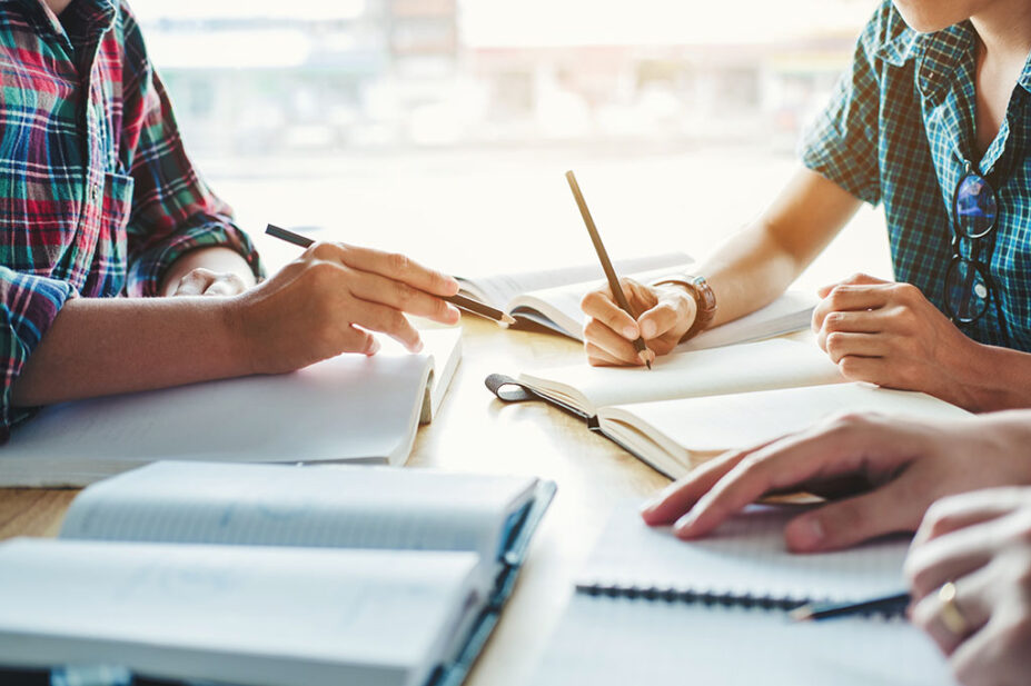 Students exchange notes during a course