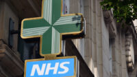 NHS pharmacy sign hanging on building in London