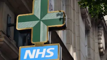 NHS pharmacy sign hanging on building in London