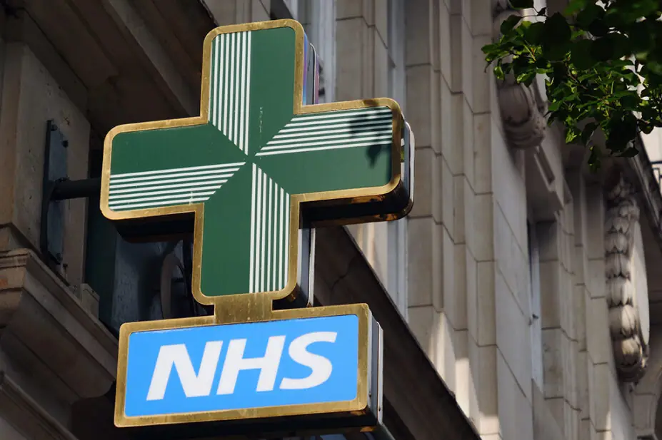 NHS pharmacy sign hanging on building in London