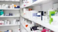 Pharmacy shelf with medicine boxes and packets