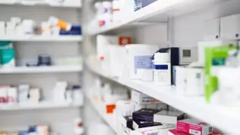 Pharmacy shelf with medicine boxes and packets