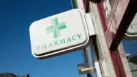 Phamacy sign on exterior of community pharmacy building