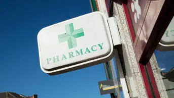 Phamacy sign on exterior of community pharmacy building