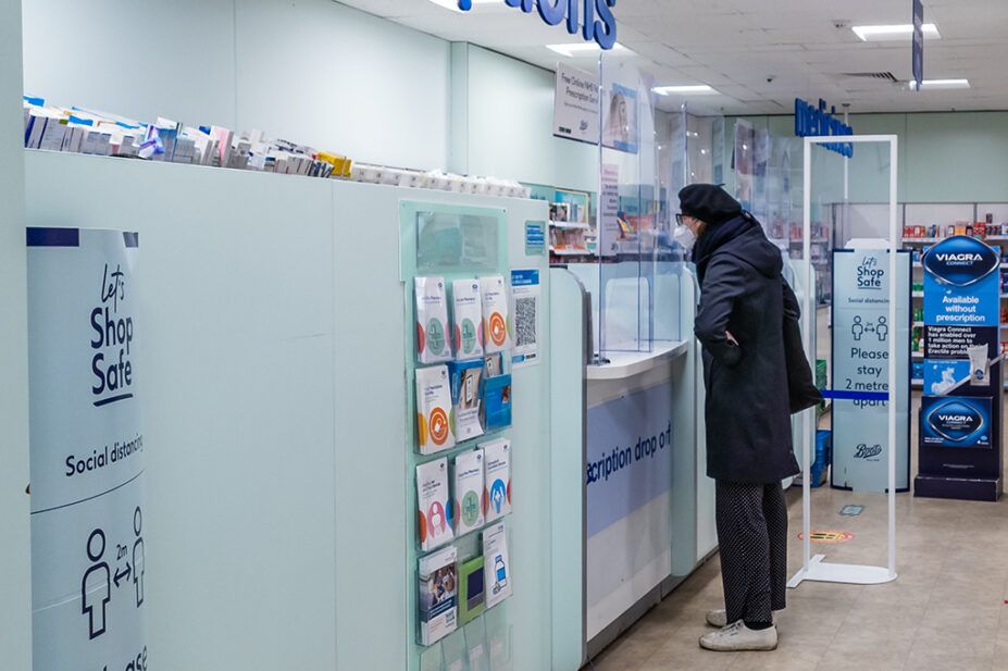 Someone standing at prescription counter in pharmacy