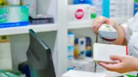 Pharmacy technician scanning medicine packet