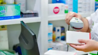 Pharmacy technician scanning medicine packet