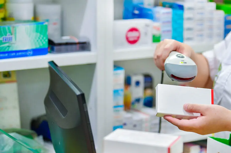 Pharmacy technician scanning medicine packet