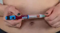 Woman holding Victoza injection pen