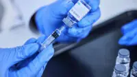 Healthcare professional prepares a COVID-19 jab