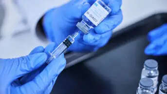 Healthcare professional prepares a COVID-19 jab