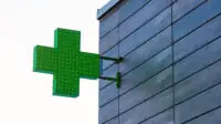 Pharmacy cross on side of building