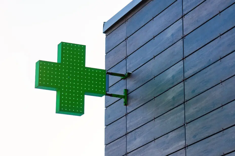 Pharmacy cross on side of building