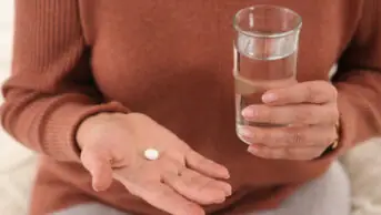 Woman holding table with a glass of water