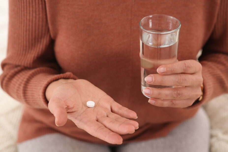 Woman holding table with a glass of water