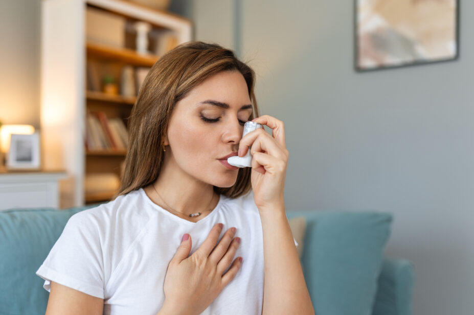 Woman uses asthma inhaler