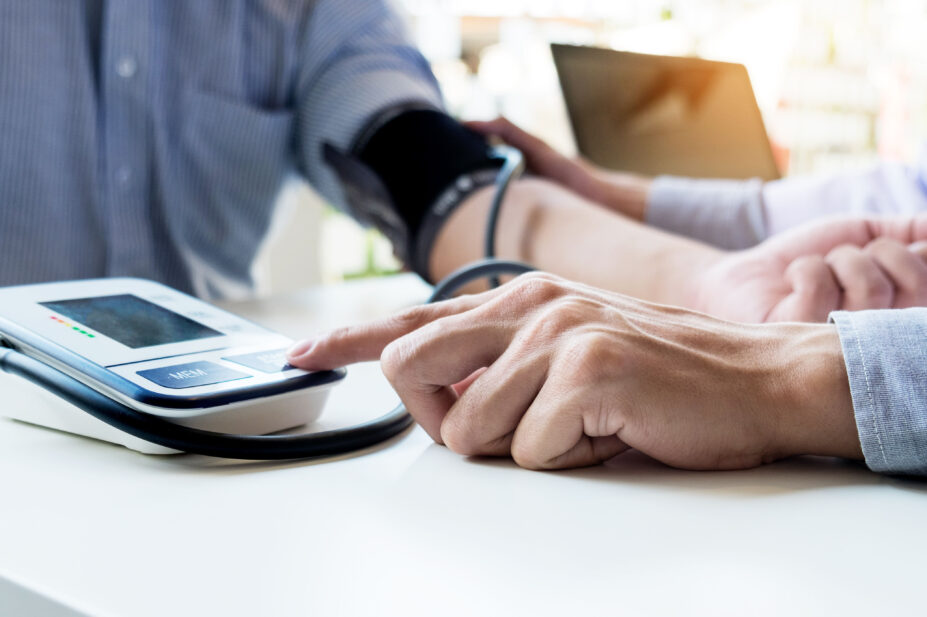 Pharmacist conducts blood pressure check on patient