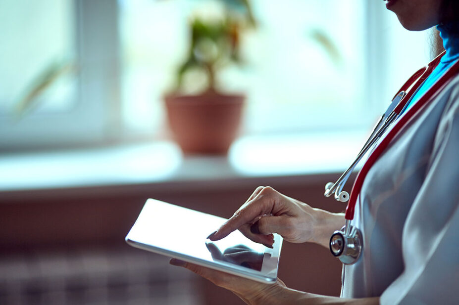 GP scrolls through health data on a tablet