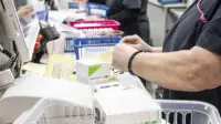 Pharmacy technician in dispensary organising medicines