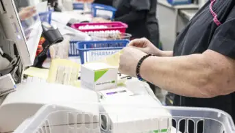 Pharmacy technician in dispensary organising medicines