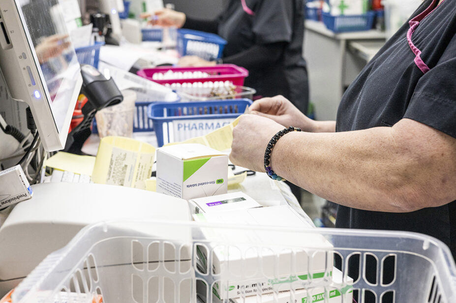 Pharmacy technician in dispensary organising medicines