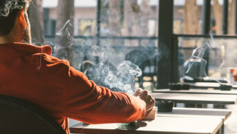 Man smoking cigarette, view from behind