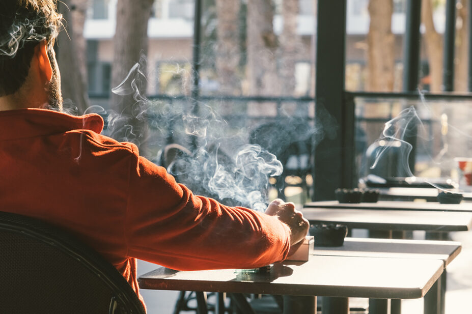 Man smoking cigarette, view from behind