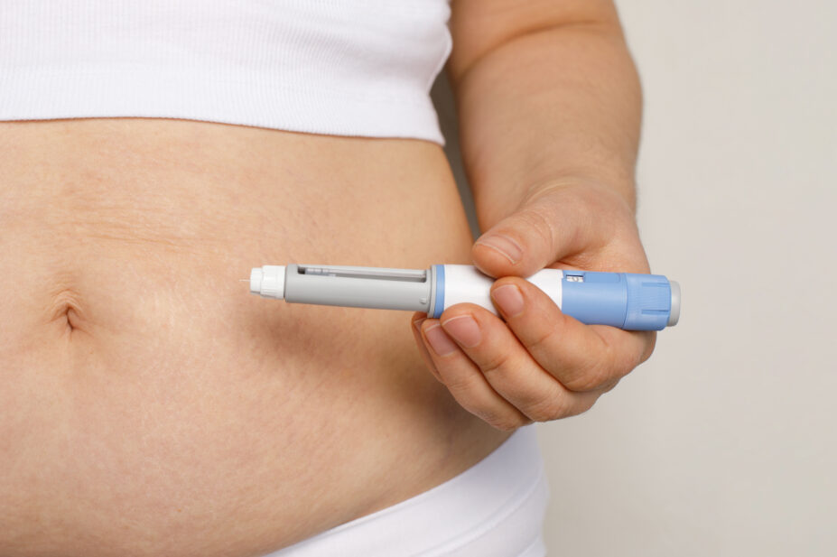 Woman holds weight-loss injection pen