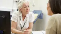 GP consults a patient