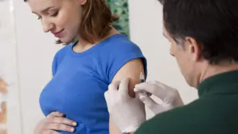 Pregnant woman getting vaccination jab