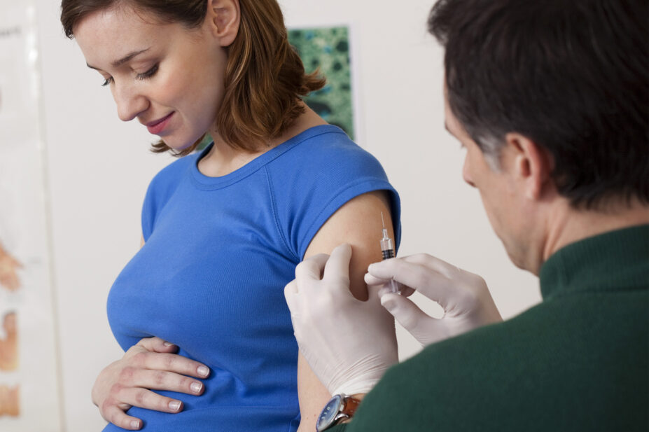 Pregnant woman getting vaccination jab