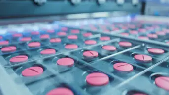 Medicine tablets on a conveyor belt during the packing process