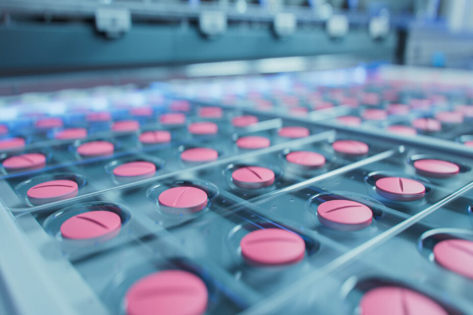 Medicine tablets on a conveyor belt during the packing process