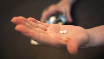 Person holds tablets in their hand