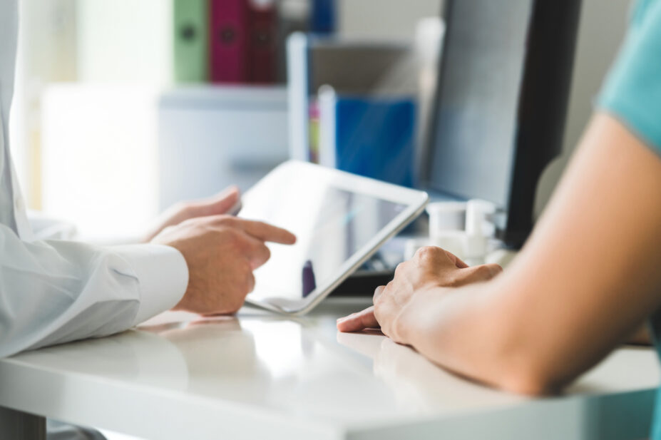 Pharmacist prescribes medicines to a patient on a tablet