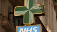 NHS pharmacy sign in street, London