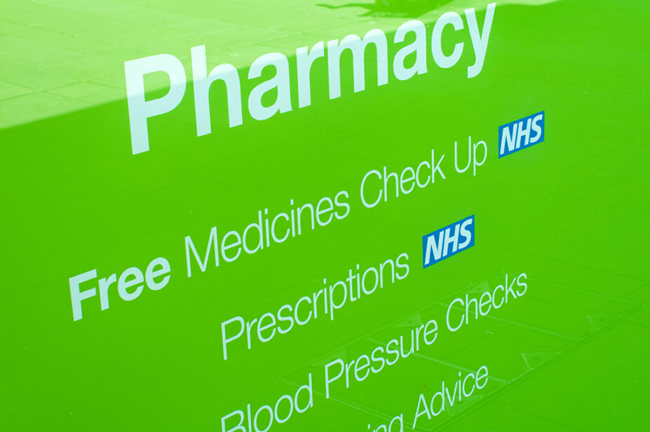 NHS prescriptions sign in pharmacy shop window