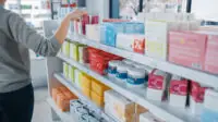 Customer browses medicines in a pharmacy