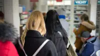 Busy pharmacy queue during winter