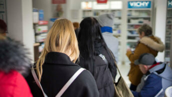 Busy pharmacy queue during winter