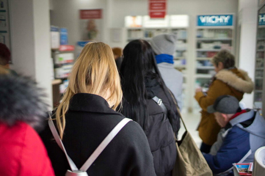 Busy pharmacy queue during winter