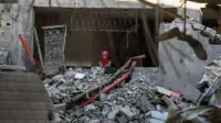 A Palestinian girl among the rubble of the Al-Huda Mosque