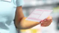 Pharmacist holds a prescription