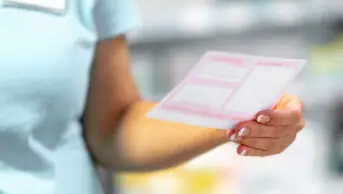 Pharmacist holds a prescription